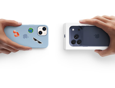 Side-by-side, hand holding iPhone 13 in silicon case with stickers on back exterior, trade-in with hand holding new iPhone box for iPhone 17