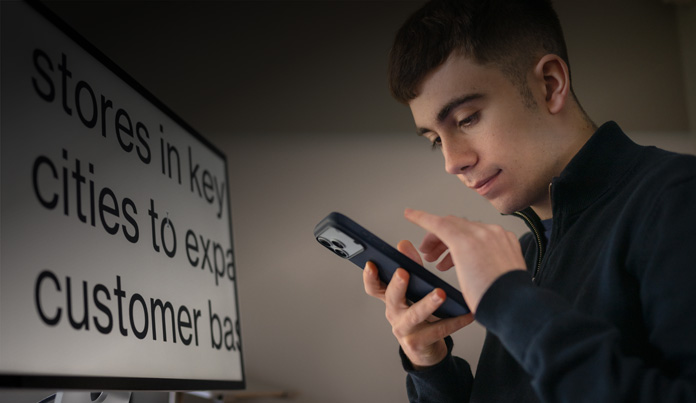 Student references their iPhone while interacting with it close to their face