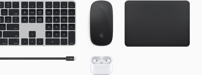 Kolekce příslušenství včetně Magic Keyboardu, Magic Mouse, Magic Trackpadu, kabelu Thunderbolt 4 Pro a AirPodů Pro.